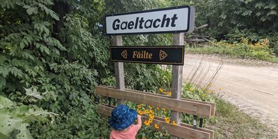 young girl at a gaeltacht sign