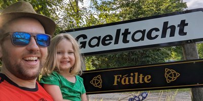 Dónall Ó Dubhghaill and his young daughter at the North American Gaeltacht sign