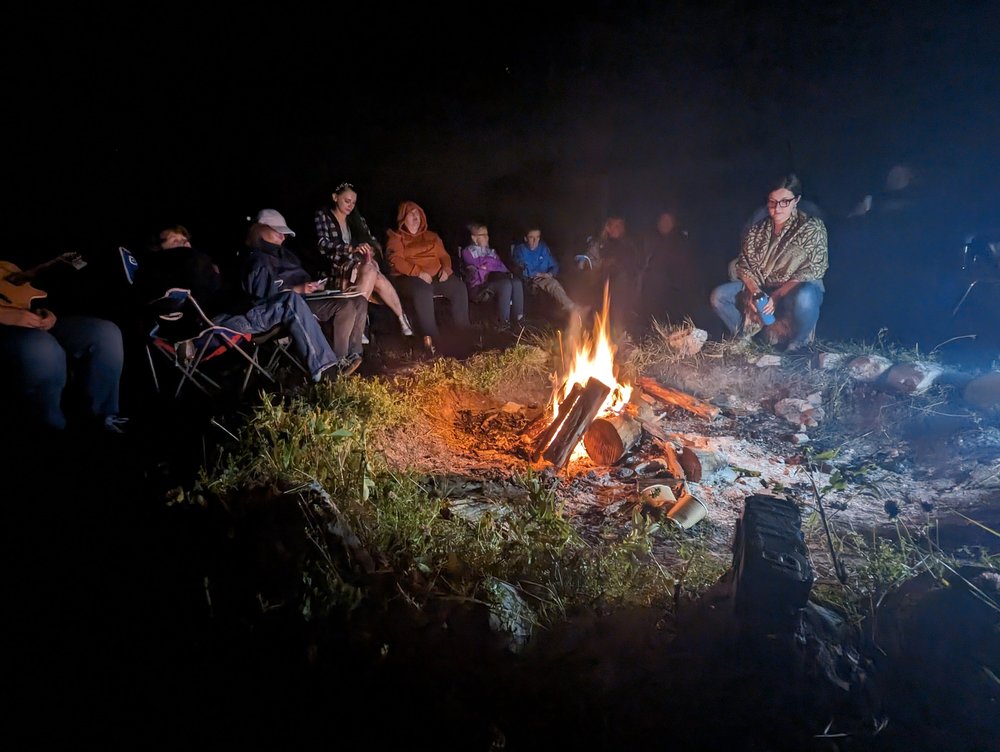 Attendees at the immersion week event at the North American Gaeltacht in Canada gathered around a campfire.