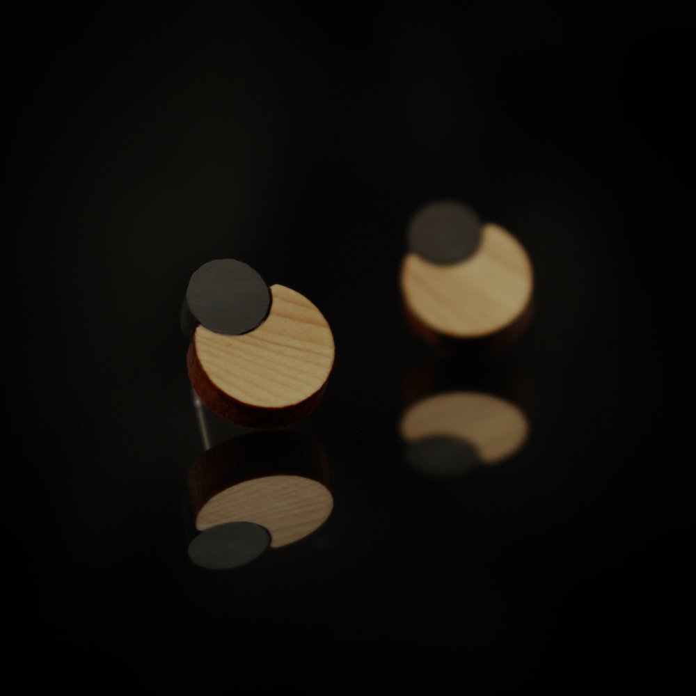 Stud earrings that feature yew that is both treated with iron oxide and untreated.