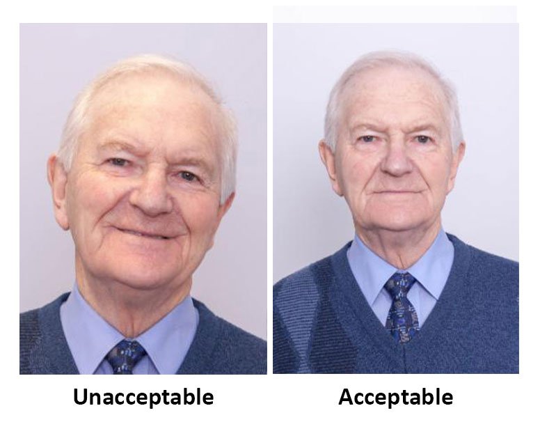 A headshot of a man smiling marked unacceptable side by side with a photo of a man with a neutral expression marked acceptable.