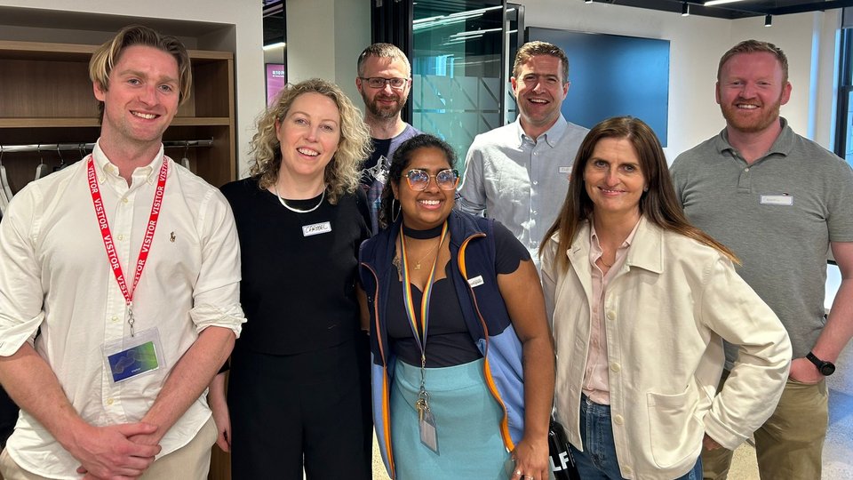 Group of people standing on a golf course