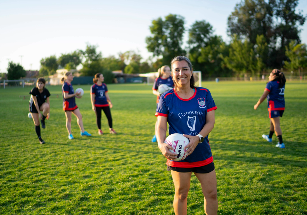 A woman in a gaelic jersey posing with a football, at a Los Andes Training Session
