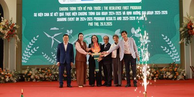 A group of people, including the Irish Ambassador, stand together on a stage marking the announcement of funding for a development cooperation programme in Vietnam.