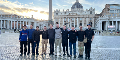 Greg Maloney (second from right) with his classmates and advisor Fr. Colin Jones at St. Peter’s Basilica