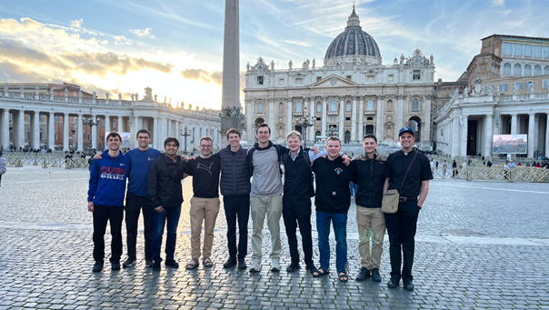 Greg Maloney (second from right) with his classmates and advisor Fr. Colin Jones at St. Peter’s Basilica