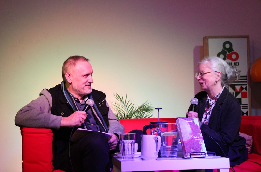 Polish poet Wojciech Bonowicz and Irish poet Alice Lyons sitting at a table