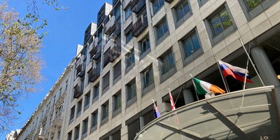View of the exterior of the Embassy building with Irish flag flying outside.
