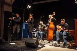 Musicians playing Irish instruments on a stage