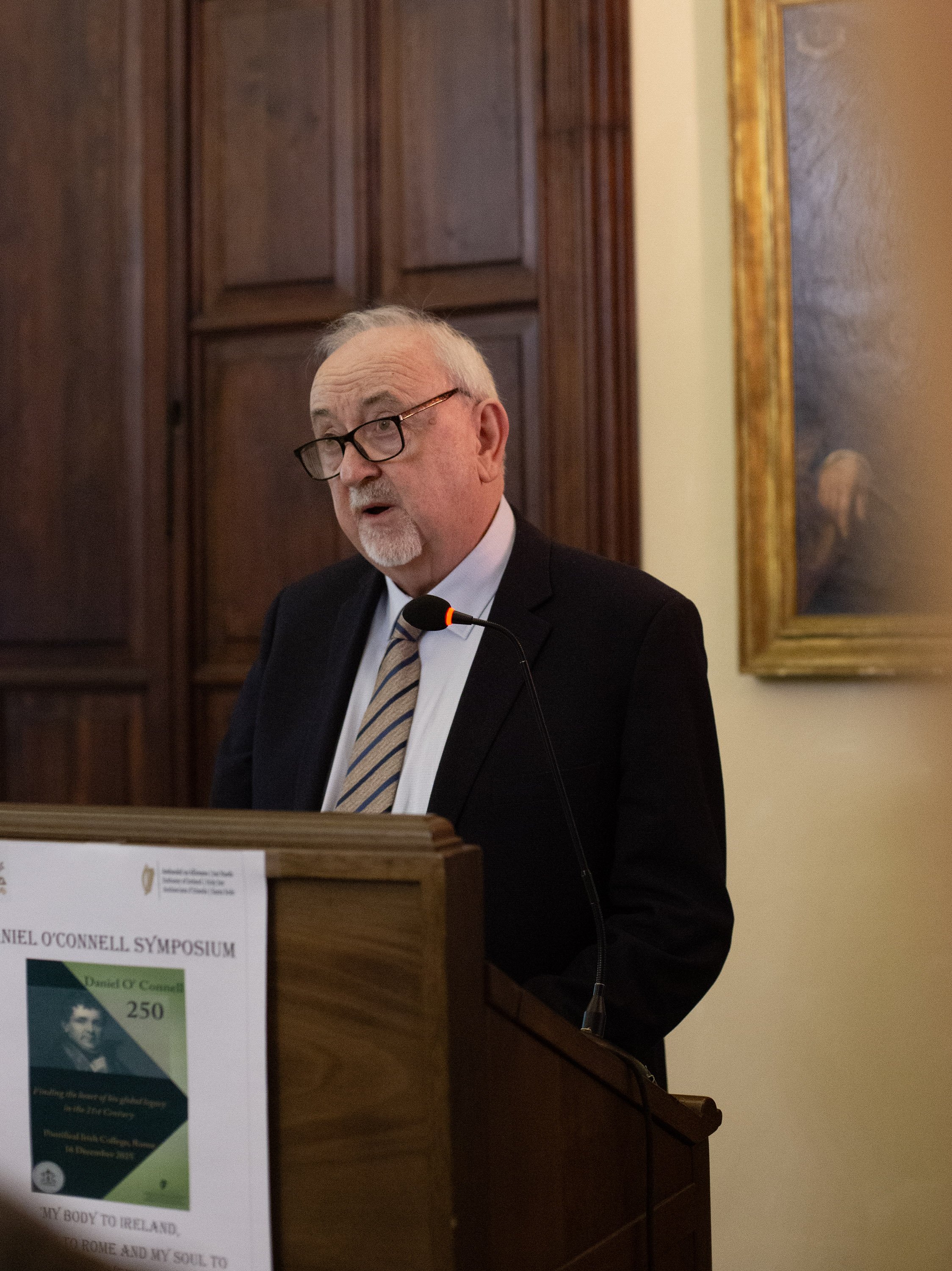 Man speaking at a plinth