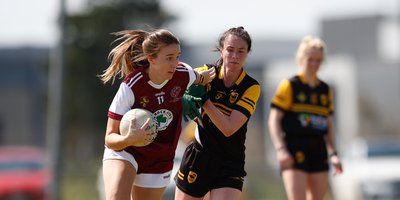 Two women tackling for the gaelic football