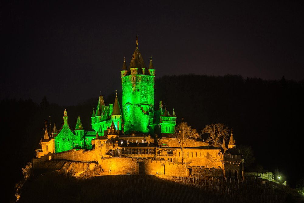 Reichsburg castle in Cochem, Germany illuminated green for St Patrick's Day