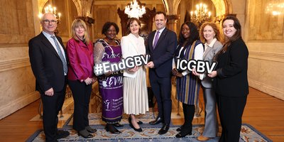 group of men and women holding cardbard prop with wording on it