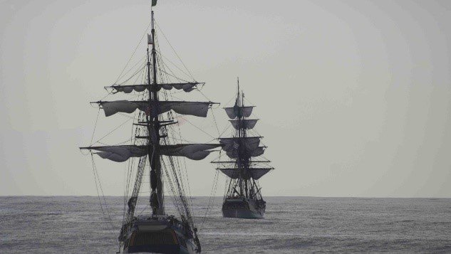 Two ships sailing away at sea