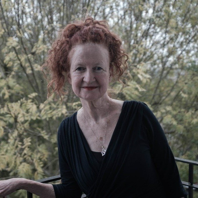 Woman standing infront of foliage