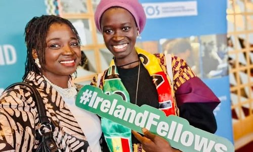 Two Senegalese fellows holding signs