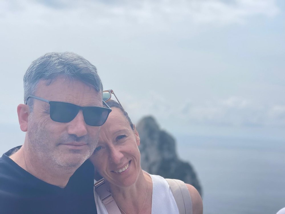 Selfie of a couple infront of a cliff and water