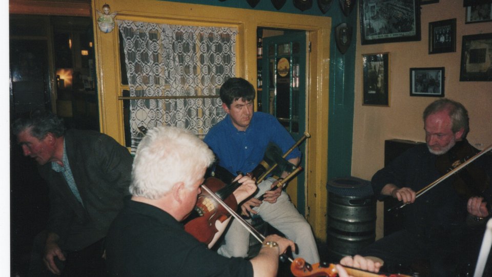 Men playing traditional Irish music at a trad session