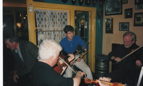 Men playing traditional Irish music at a trad session