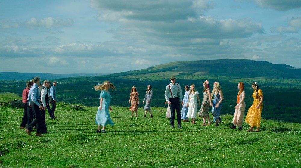 A group of people in a green field