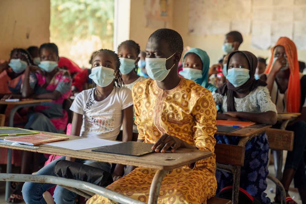 Ndiambe in classroom with classmates