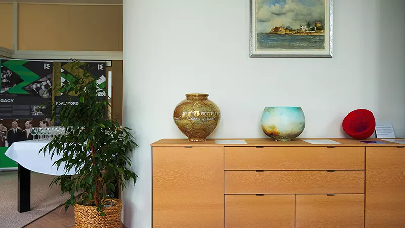 three colourful bowls on a wooden sideboard