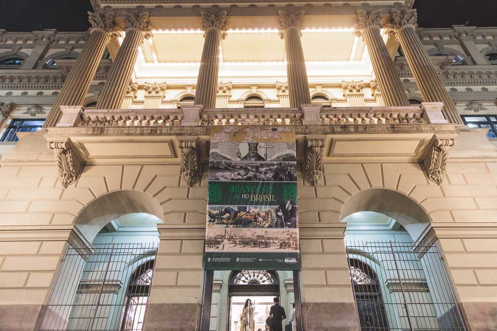 The exterior of a building showing the poster for the exhibition hanging over the door.
