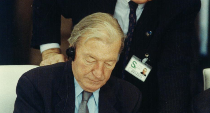 Former Taoiseach Charles Haughey signs the Charter of Paris