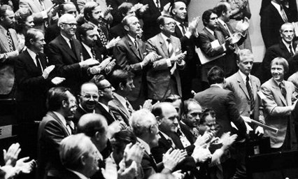 Black and white photo of people giving a standard ovation
