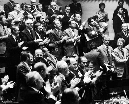 Black and white photo of people giving a standard ovation