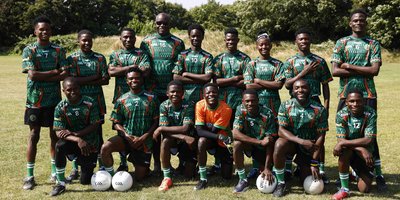 group of football players with gaelic football in bright green and orange jerseys