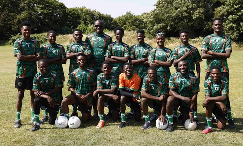 group of football players with gaelic football in bright green and orange jerseys