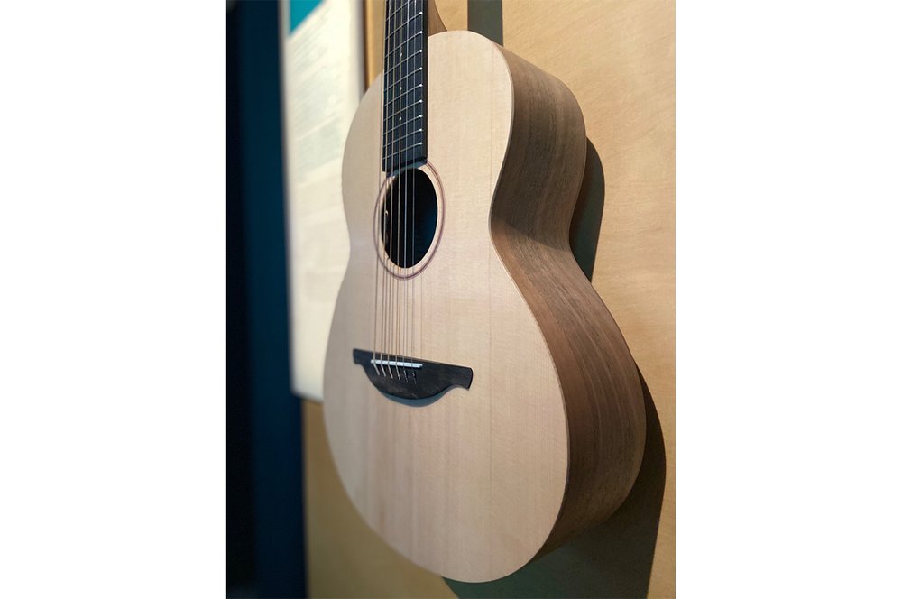 A guitar hung on a wall.