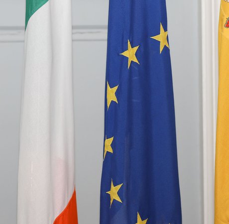 Irish and Spanish national flags with the European flag in the middle