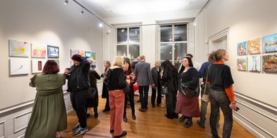 A crowd viewing an art exhibition