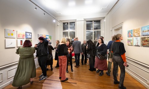 A crowd viewing an art exhibition