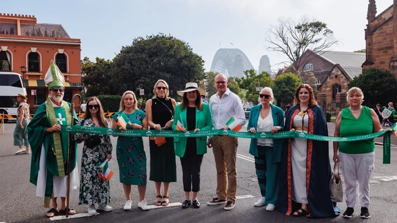 sydney st patrick's day people holding a green sash with harbour bridge in the background