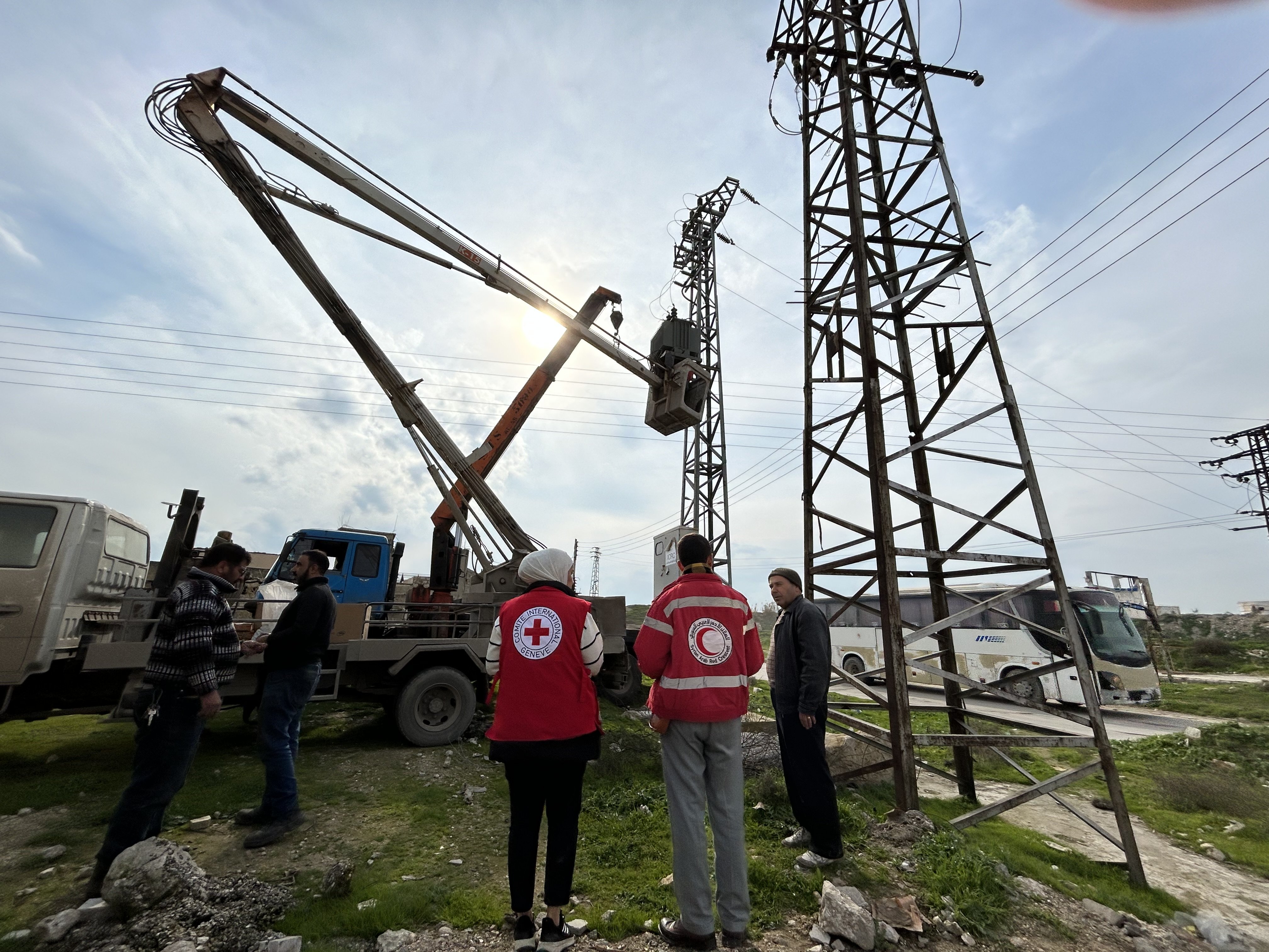 Two Red Cross workers supervising a delivery of aid