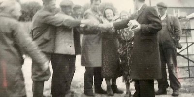 Men putting their hands together