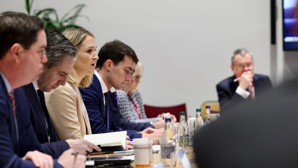 ministers along the side of a board room table