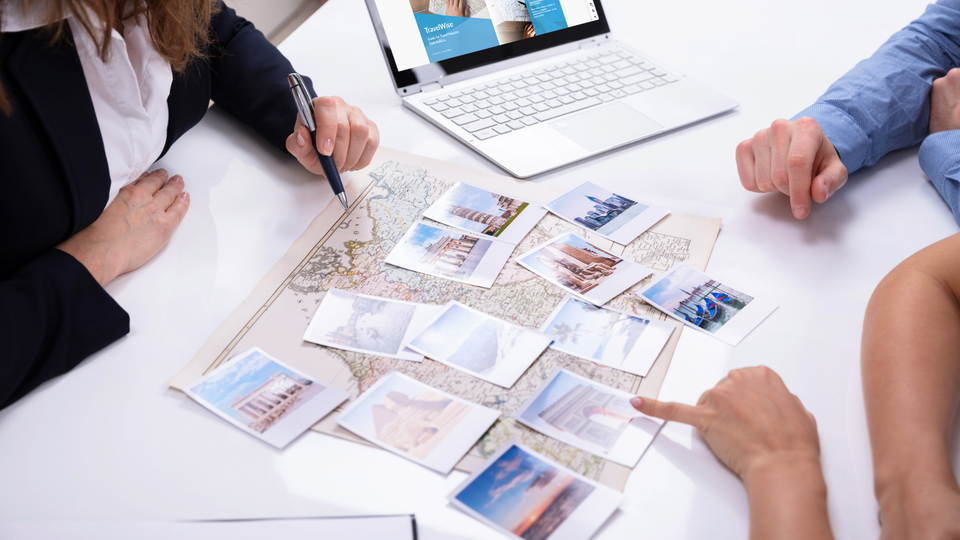 Group of people looking over a map and planning travel