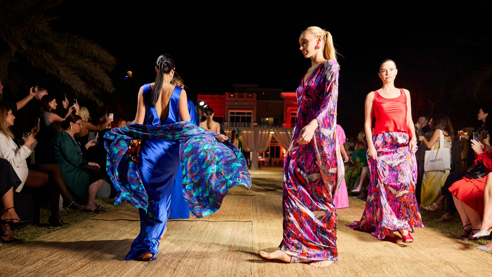 Models walking on a runway at night