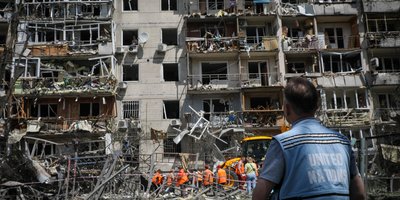 UN Volunteer outside bomb site.