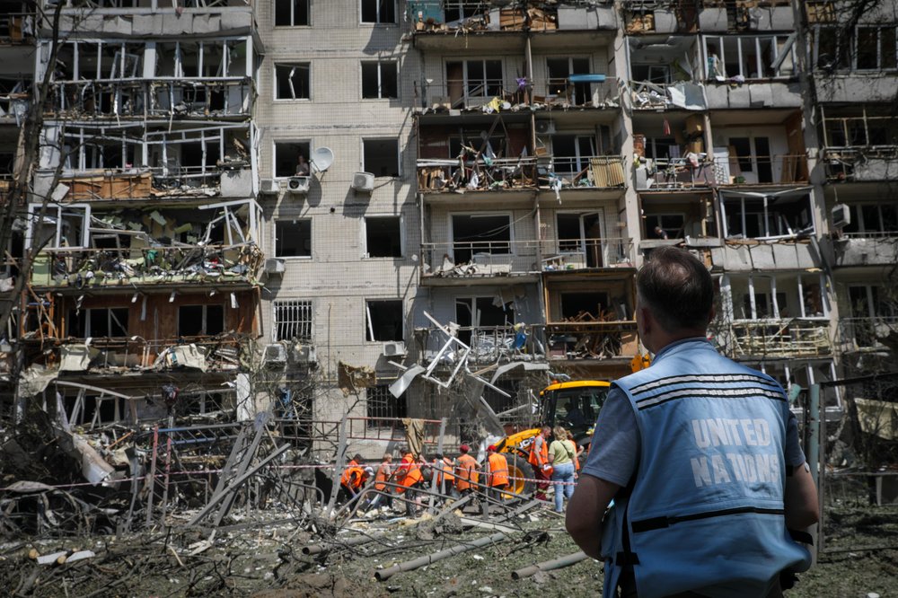 UN Volunteer outside bomb site.