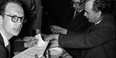 Anthony Cronin, unidentified man standing, Patrick Kavanagh, Flann O'Brien signing book, Bloomsday, Davy Byrnes pub, Duke Street, Dublin