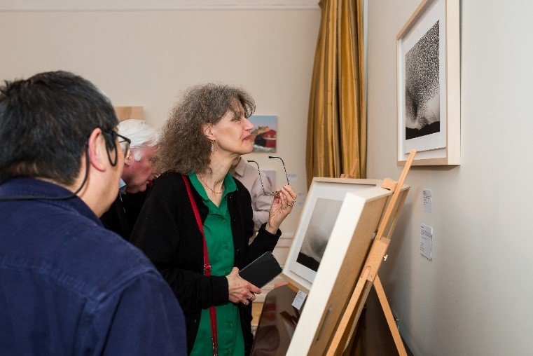 Woman looking at painting in an exhibition