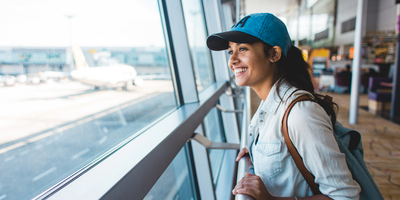Woman looking out window at airport