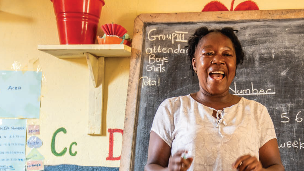 Woman teaching in front of a blackboard