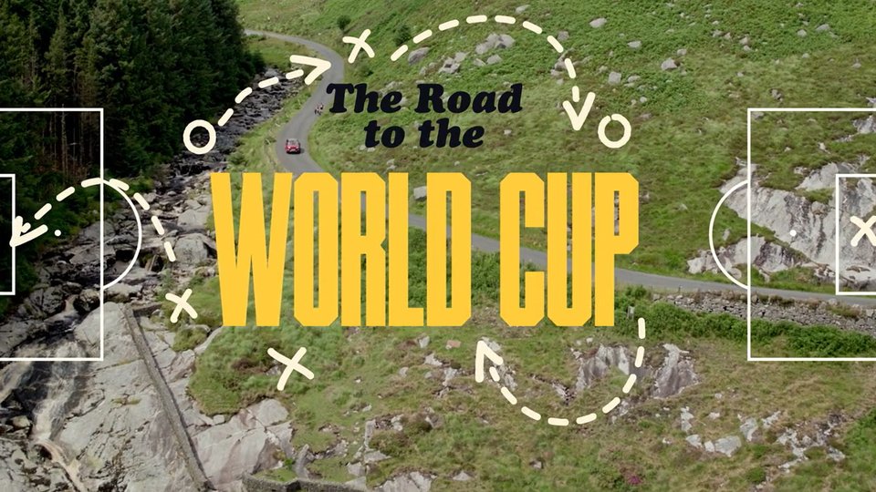 car on a cliff road with the road to the world cup written over it