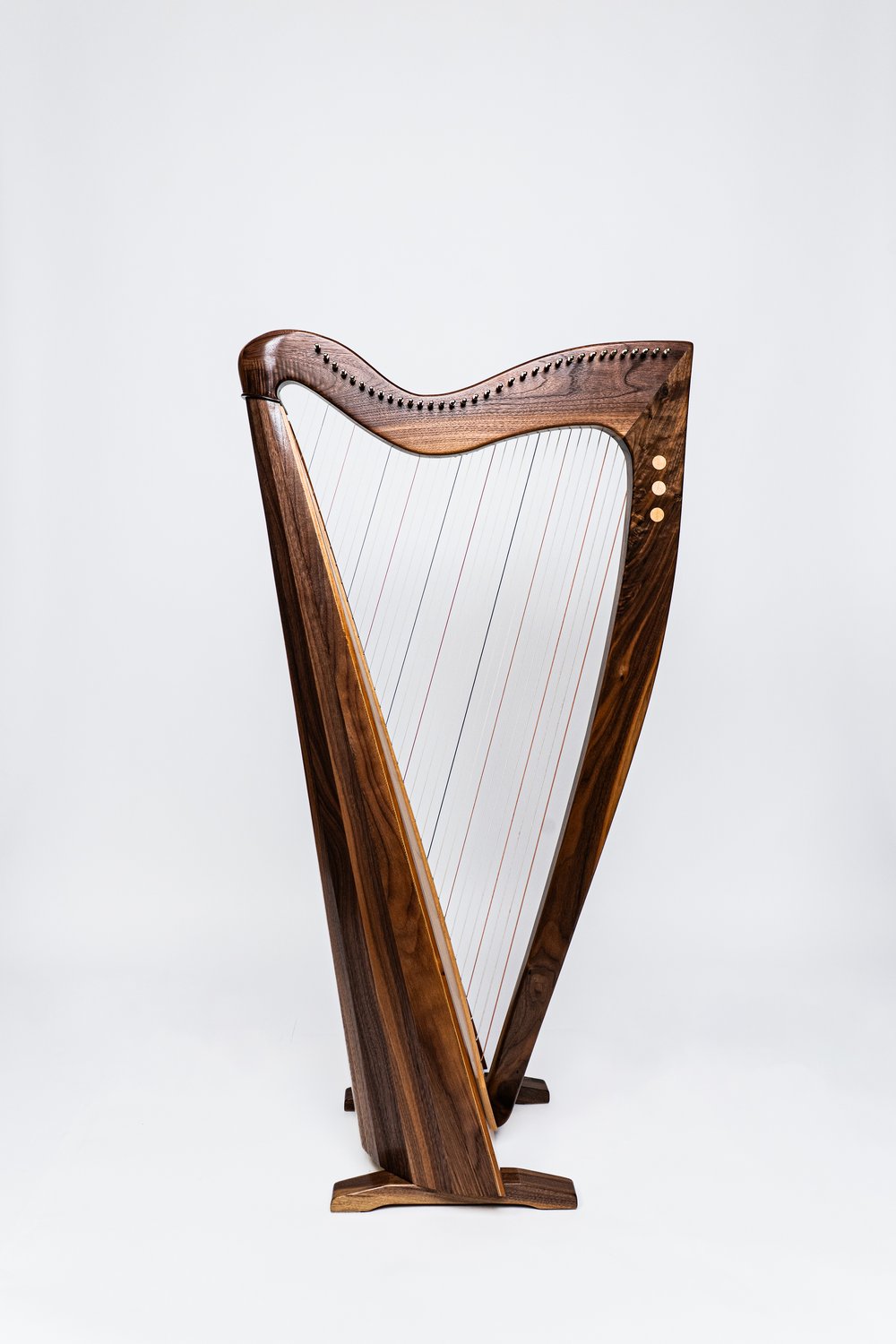 Standalone image of a handmade harp in dark wood